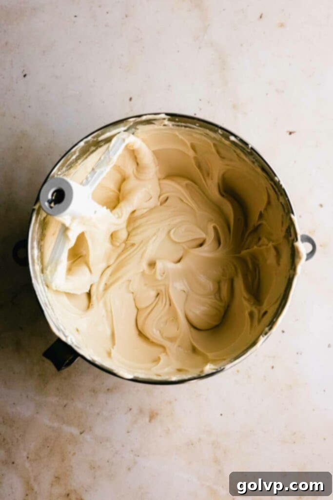 Beating cream cheese and sugar together for the cheesecake filling