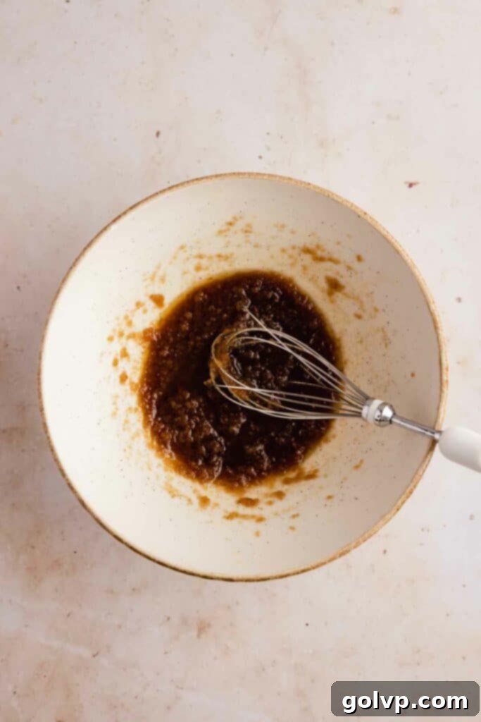 whisking melted butter and sugars