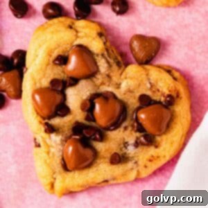 Heart shaped chocolate chip cookie on counter with chocolate hearts, representing the delicious result of this easy recipe.