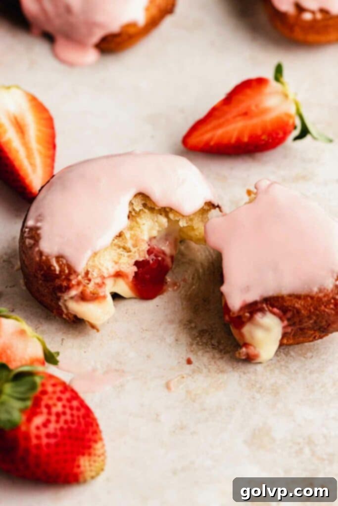 torn apart strawberry and custard filled donut 