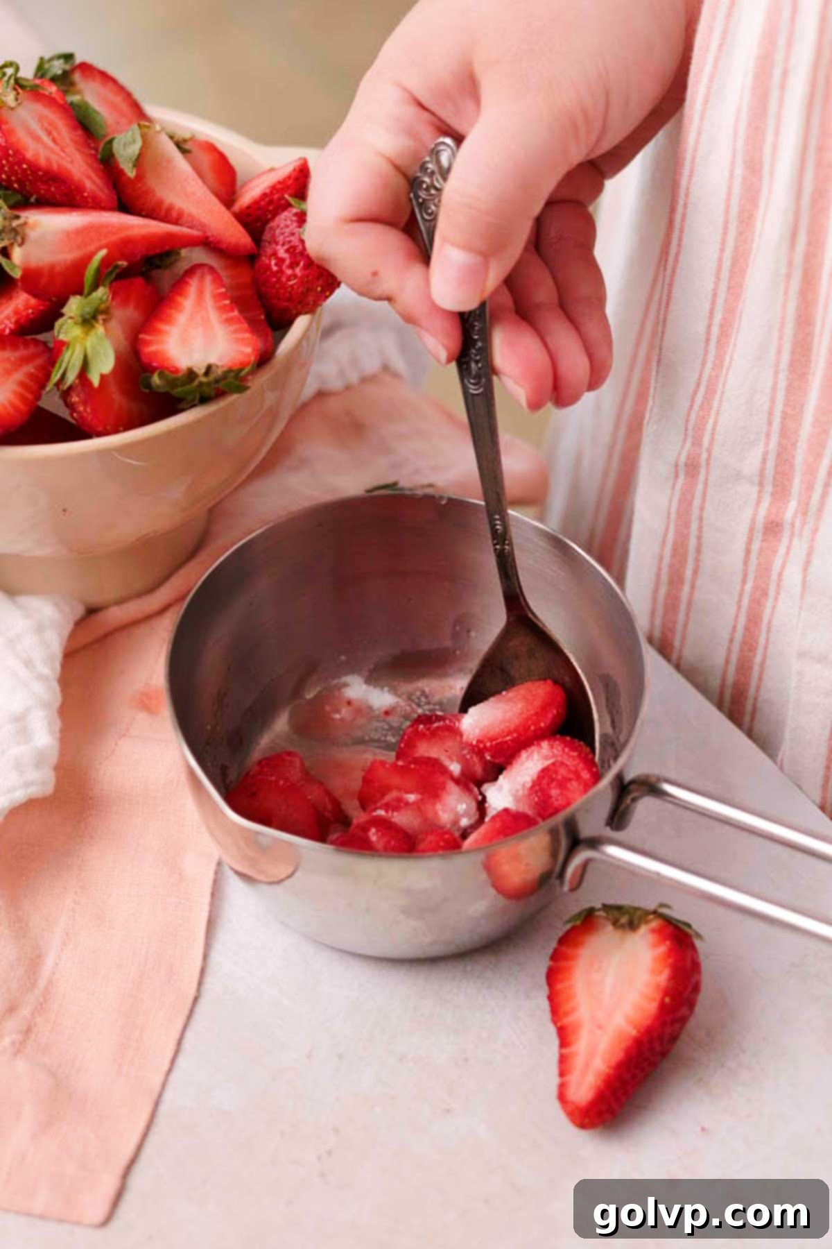 Stirring diced strawberries, lemon juice, sugar, and cornstarch in a small saucepan.