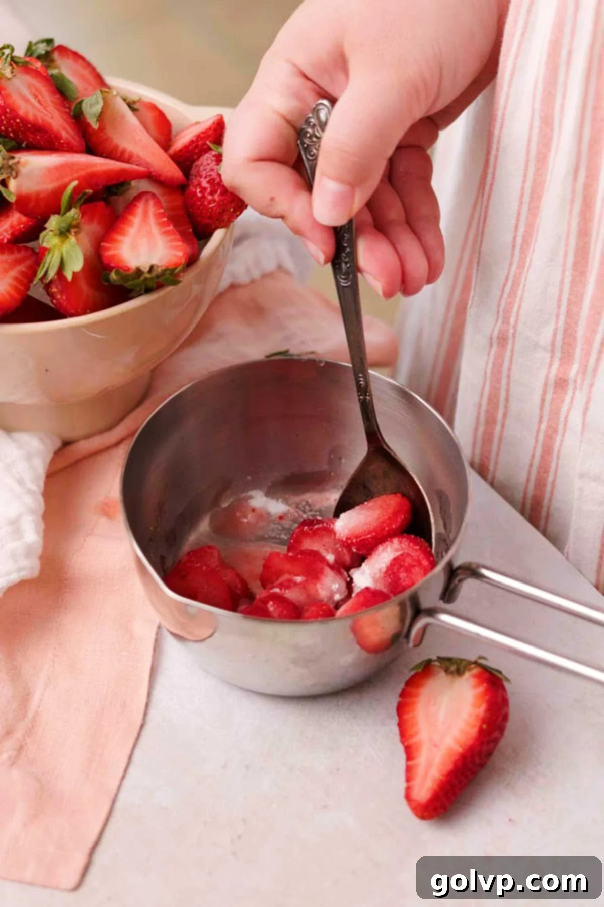 Decadent Strawberry Cheesecake Cookies 5 Stirring strawberry sauce ingredients in a small saucepan over medium-low heat