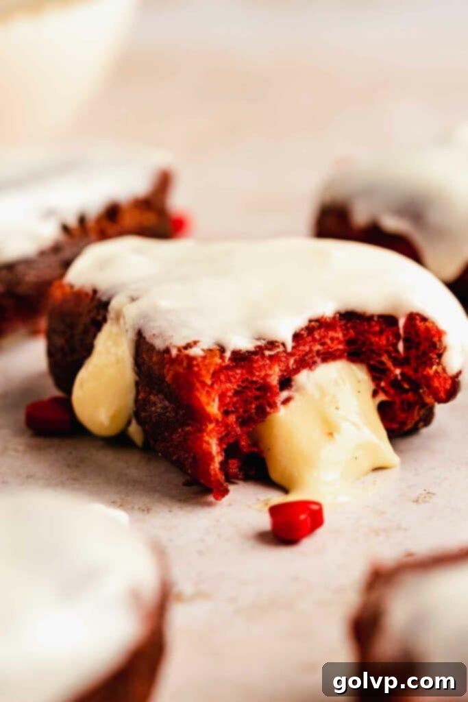 Red velvet glazed donut with custard filling oozing out