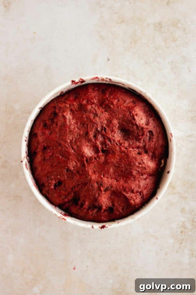 risen red velvet dough for donuts in a bowl