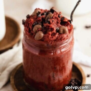 Red velvet cookie dough in jar with spoon