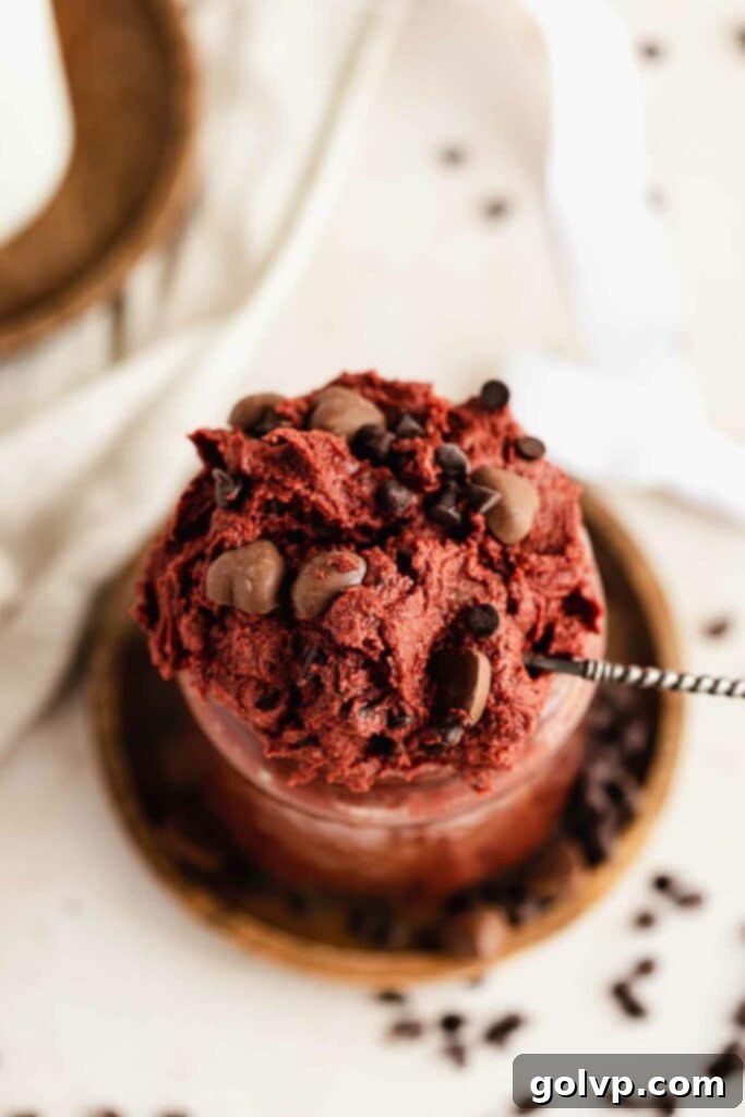 closeup of red velvet cookie dough with milk chocolate chips in jar