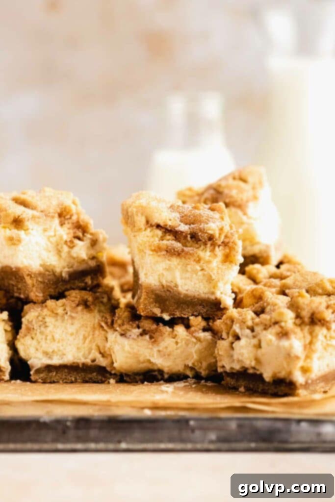 Snickerdoodle Swirl Cheesecake Bars 5 Pile of snickerdoodle cheesecake bars on baking tray