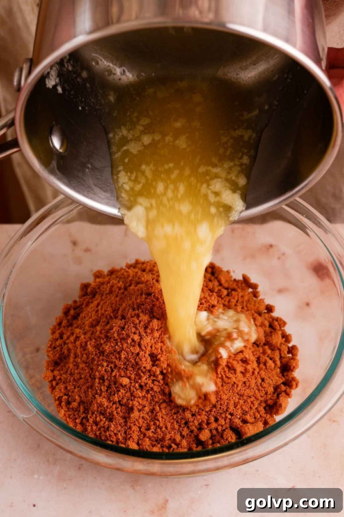 Crushing Biscoff cookies to create the perfect cheesecake crust.