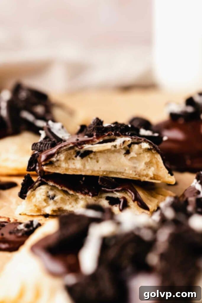 Broken apart homemade Oreo Pop Tart revealing the generous, creamy cookies and cream filling.