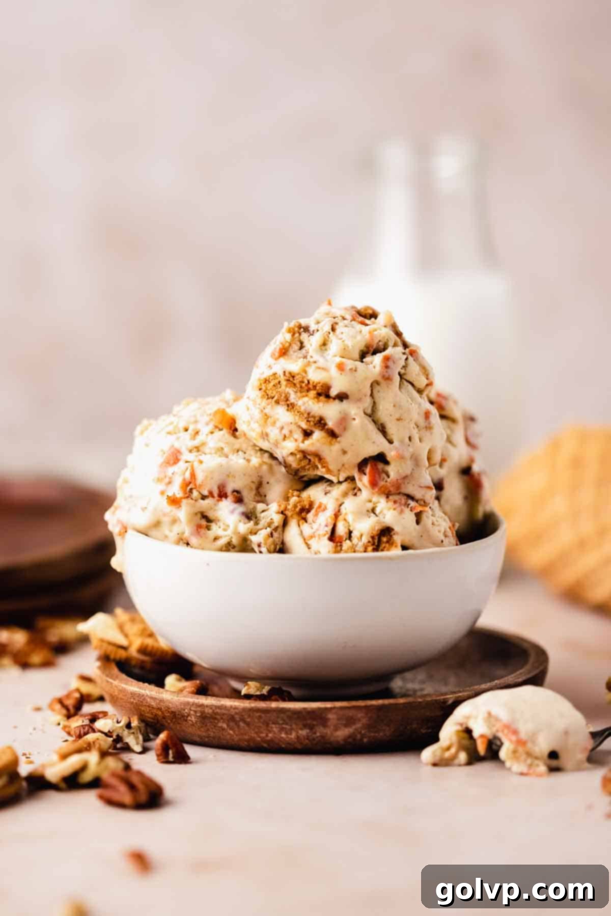 Spiced Carrot Cake Swirl 3 creamy carrot cake ice cream in a bowl with a spoon, ready to be eaten