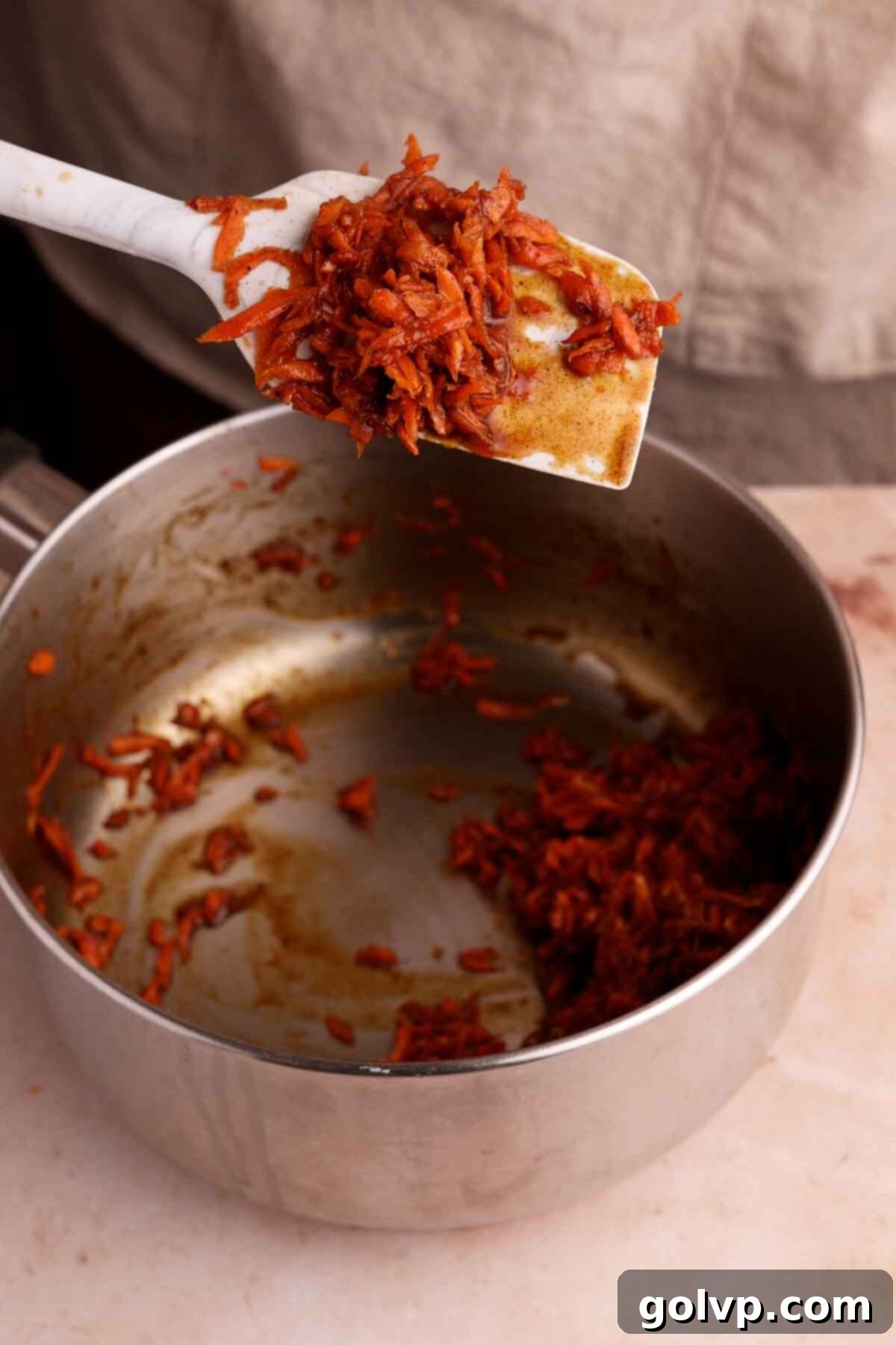 Spiced Carrot Cake Swirl 4 cooked shredded carrots with spices in a saucepan
