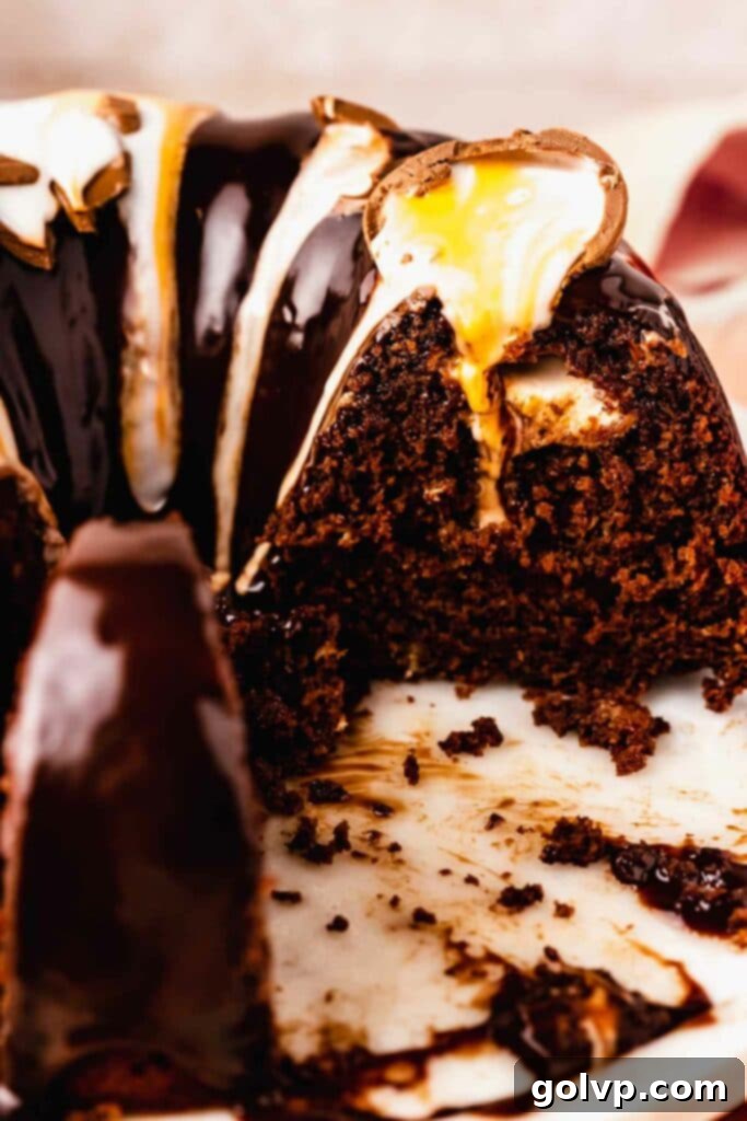 A slice of moist chocolate bundt cake revealing a molten Cadbury creme egg filling inside, perfect for Easter.