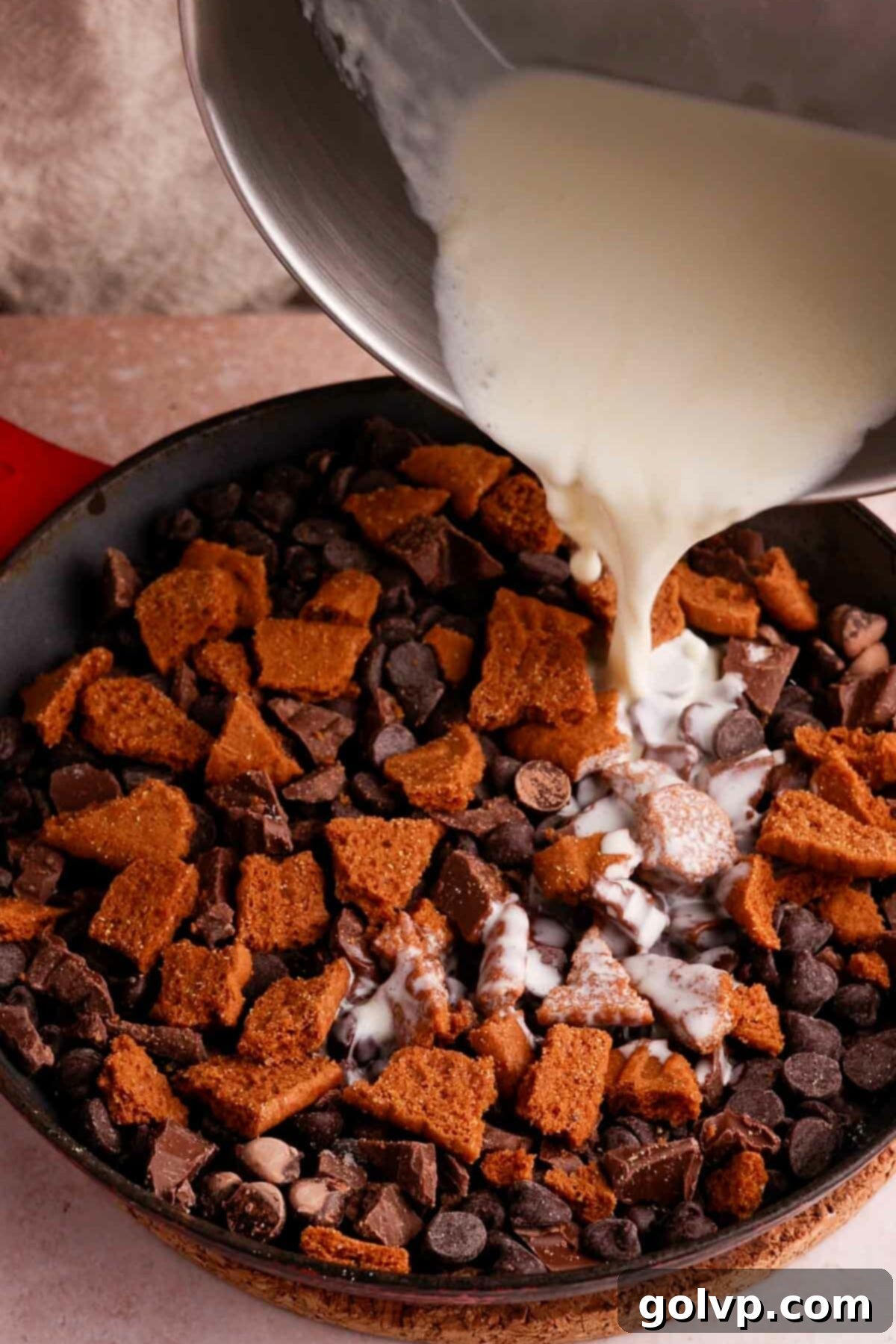 pouring cream on top of chocolate in skillet