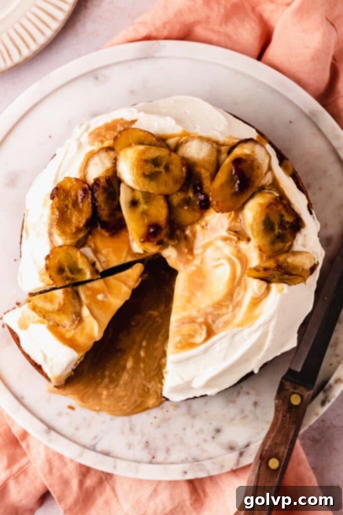 cutting a slice of a beautifully layered banoffee cake with visible bananas and caramel sauce