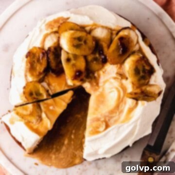 cutting a slice of cake with bananas and caramel sauce