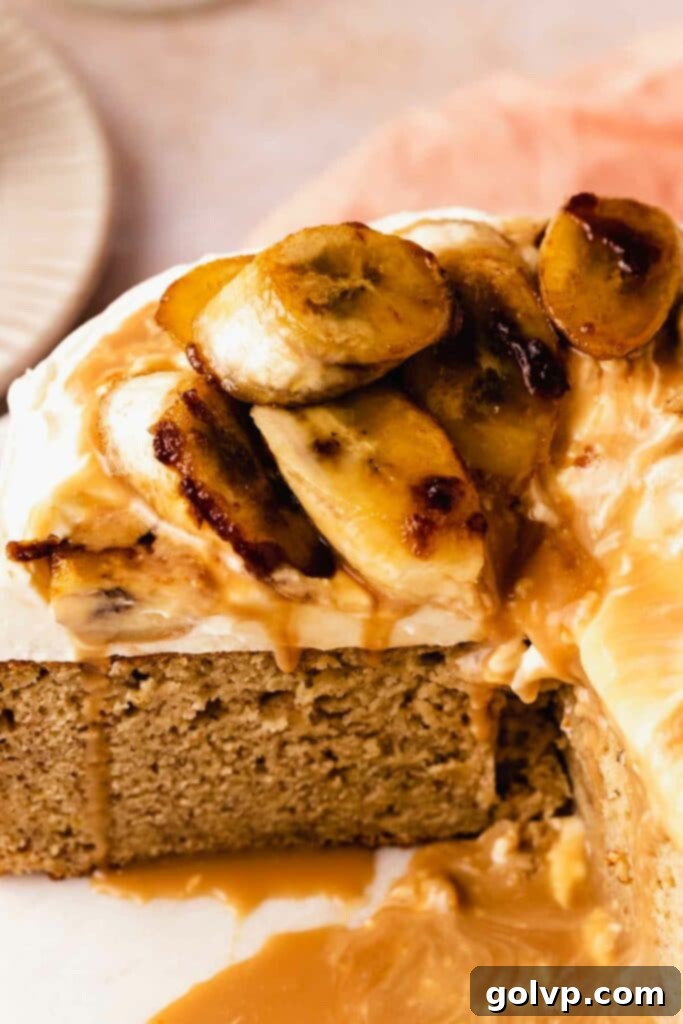 banana cake topped with luscious caramelized bananas, whipped cream, and toffee drizzle