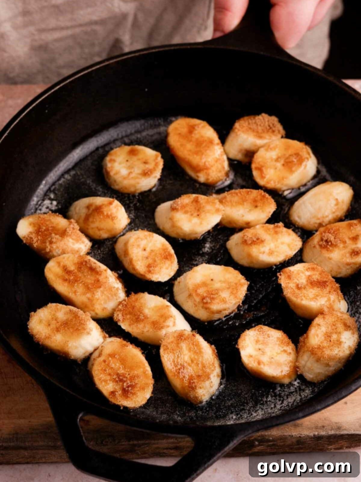 frying banana pieces in butter to caramelize them