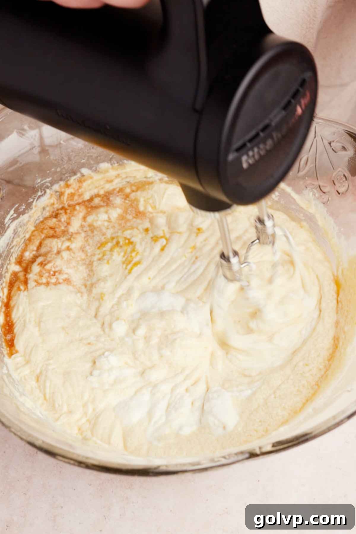 beating wet ingredients for blueberry cake batter