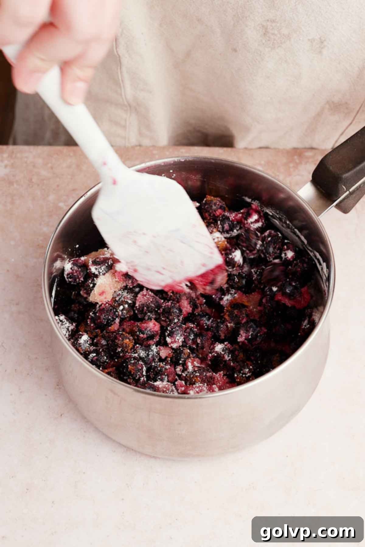 stirring frozen blueberries, sugar, lemon juice, and cinnamon in a small saucepan for filling