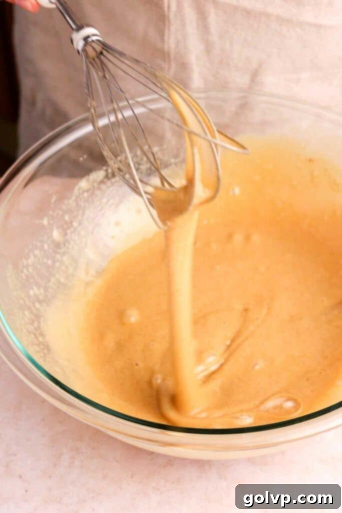 Whisking eggs and sugar until pale and thick for a crinkly top brownie