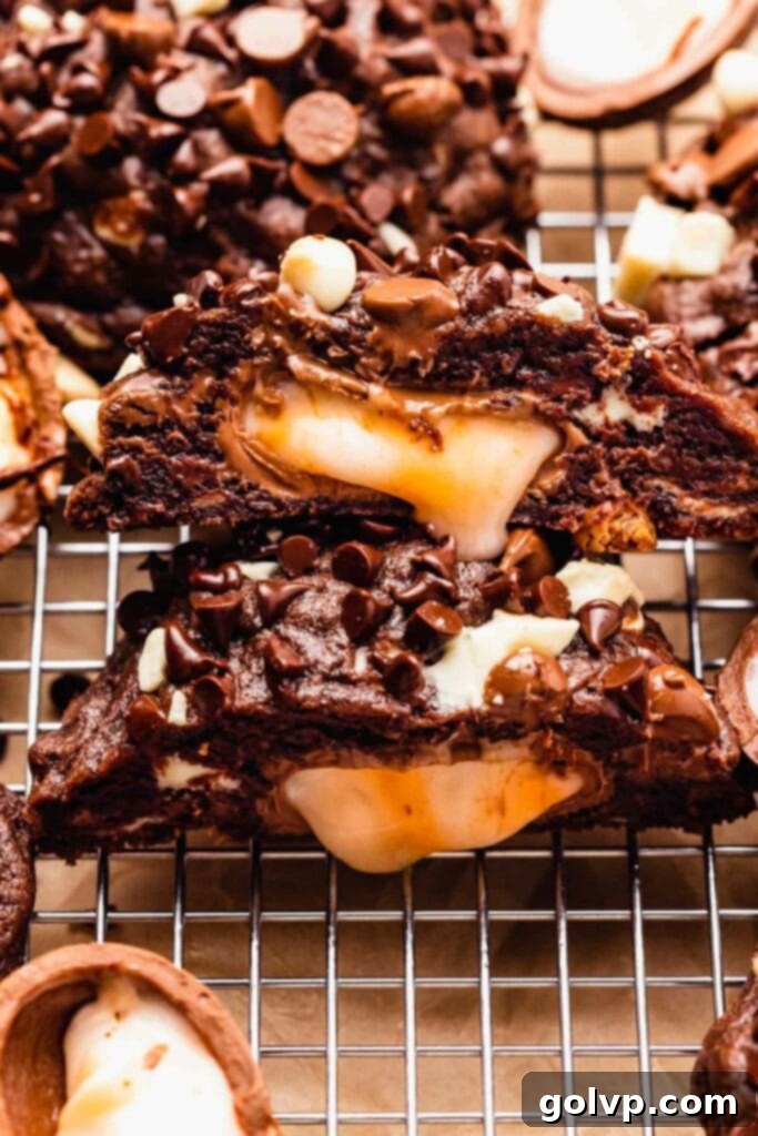 Cut open chocolate cookie with creme egg in middle, showcasing the gooey filling