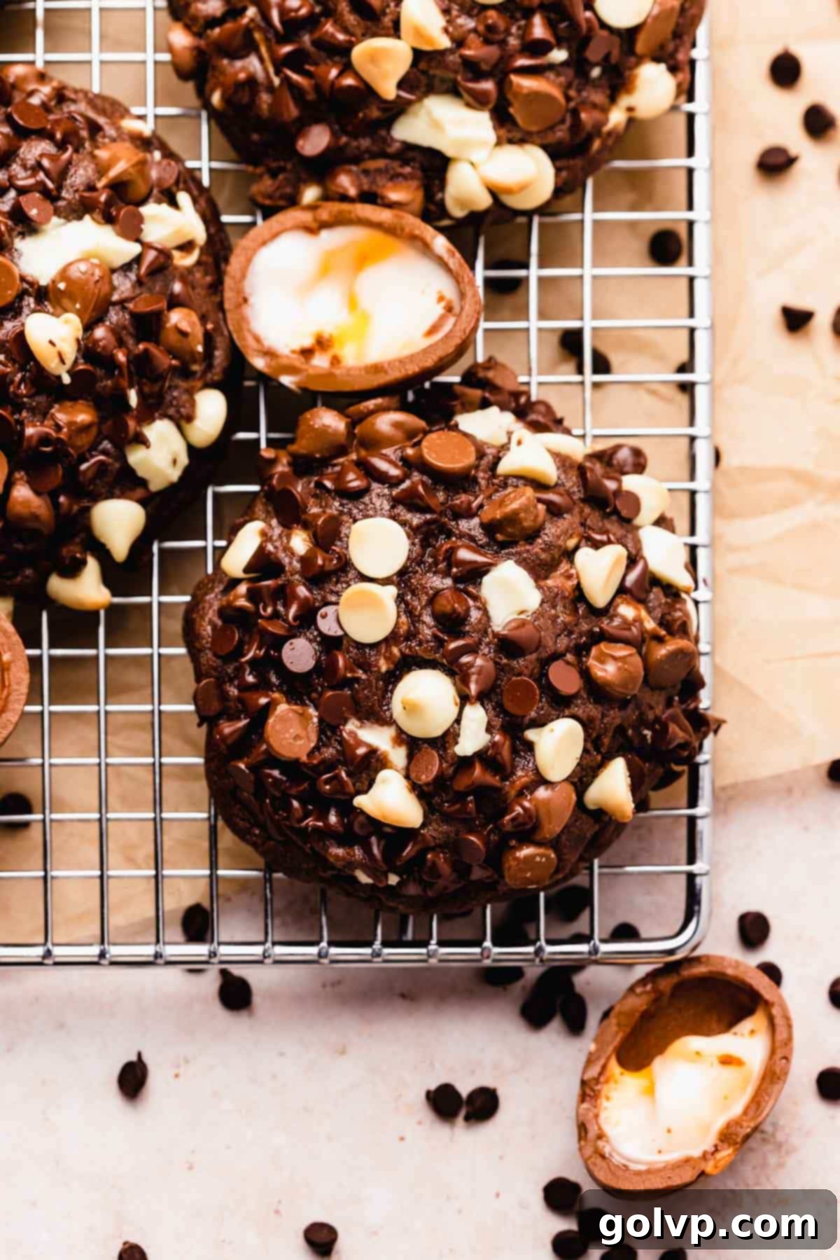 A warm chocolate creme egg cookie cooling on a wire rack
