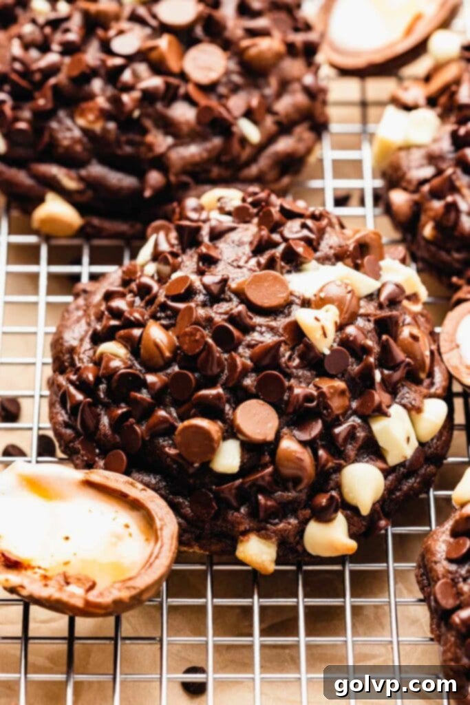 Close-up of a chocolate cookie covered in milk and white chocolate chips, with Cadbury creme eggs