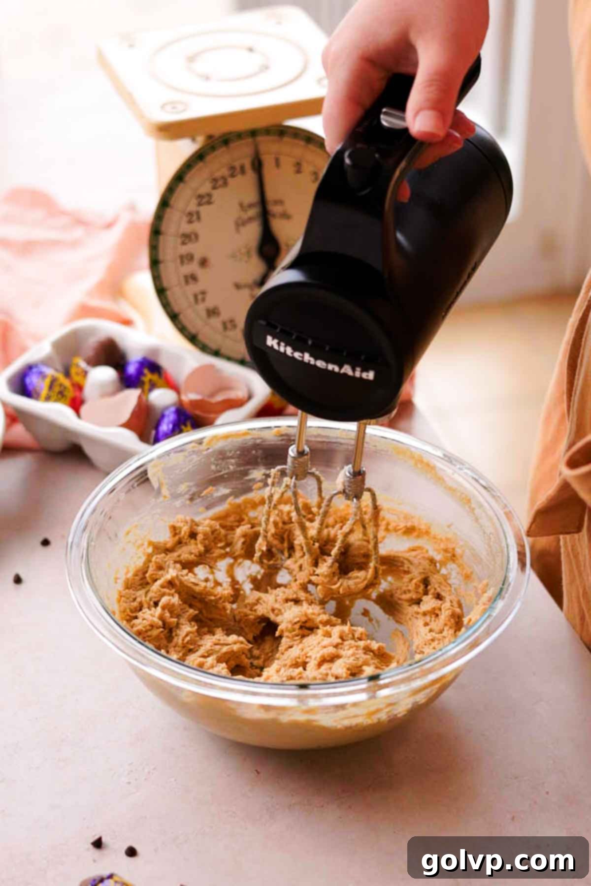 Creme egg cookie dough wet ingredients mixed smoothly in a bowl