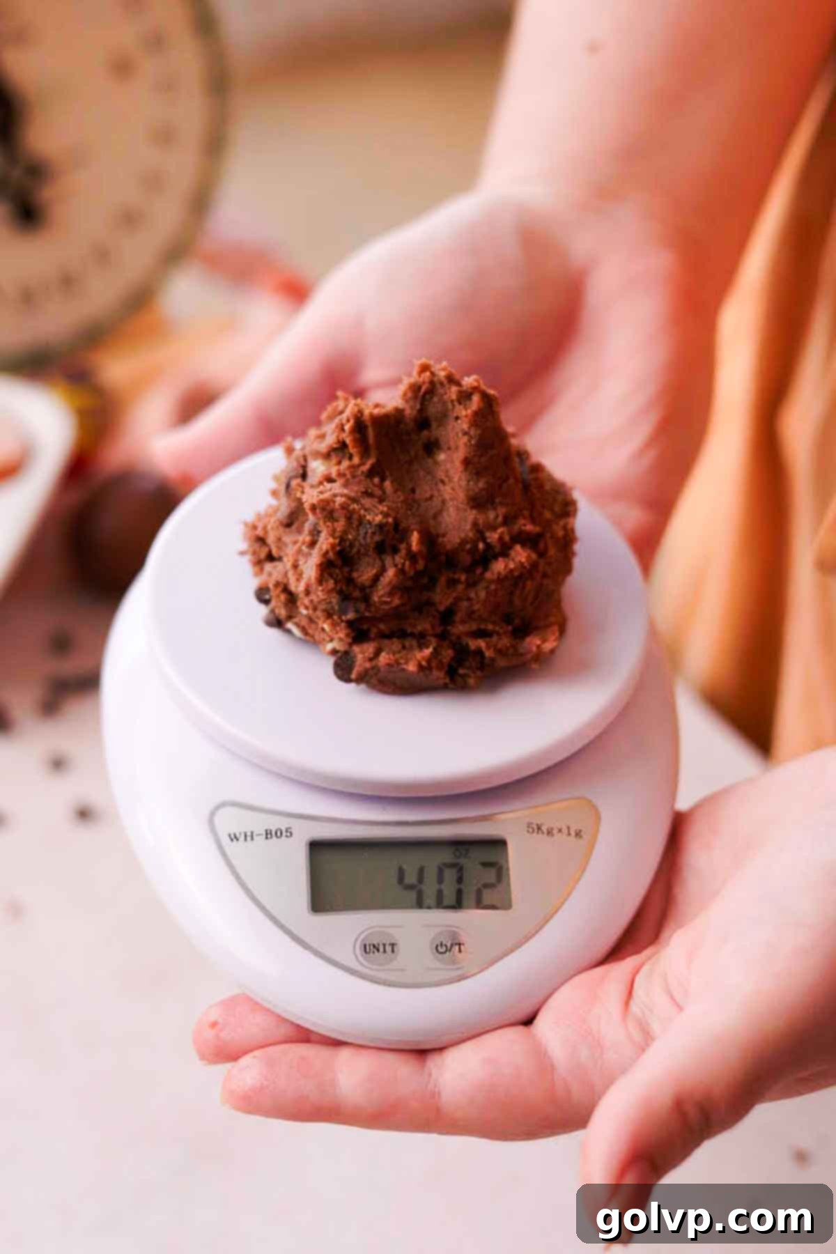 Weighing portions of creme egg cookie dough for consistency