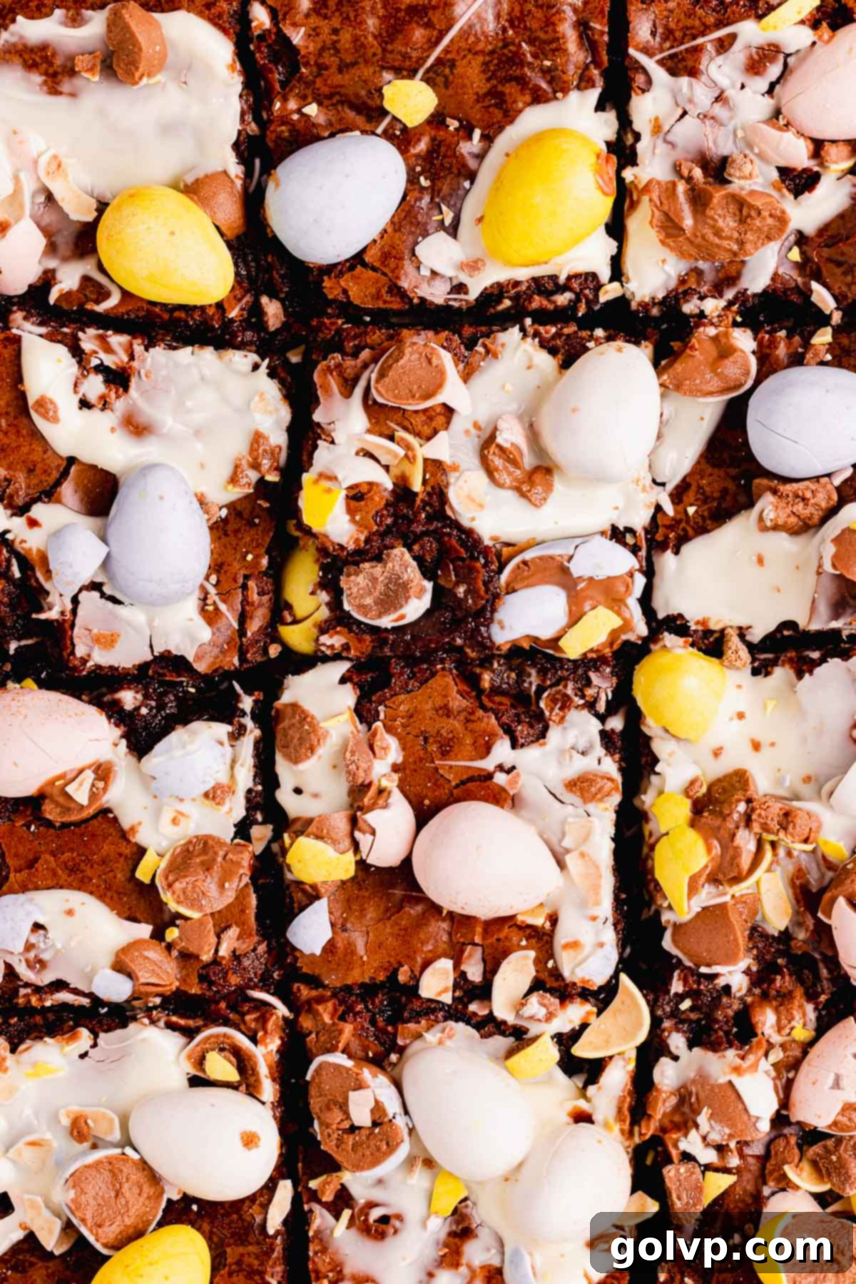 brownies with smeared white chocolate and crushed chocolate mini eggs on top, ready to be served