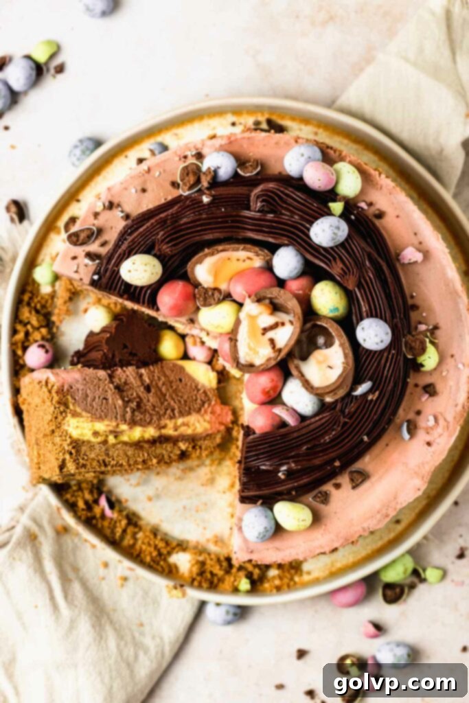 Mini egg cheesecake with nest and a slice cut out, showcasing chocolate and pastel swirls