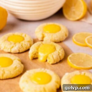 lemon curd filled cookies with one bitten cookie and lemon curd oozing out