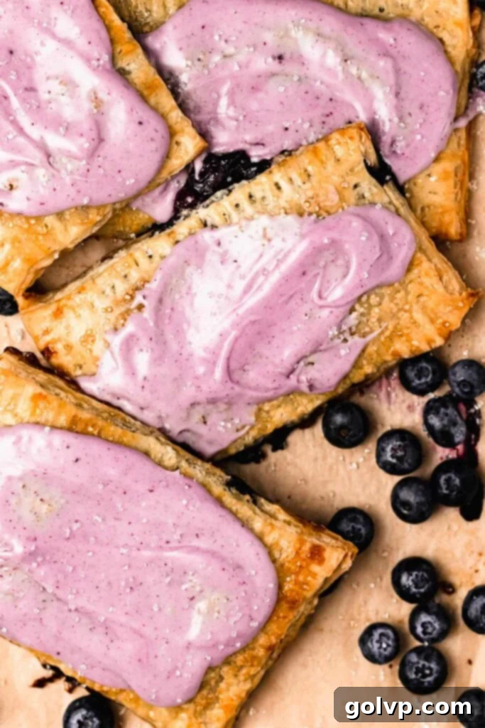 Blueberry pop tarts with vibrant purple blueberry glaze, stacked