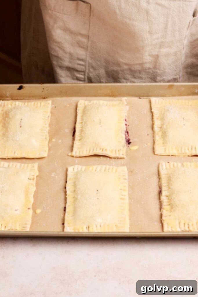 Unbaked blueberry pop tarts on baking tray, ready for the oven