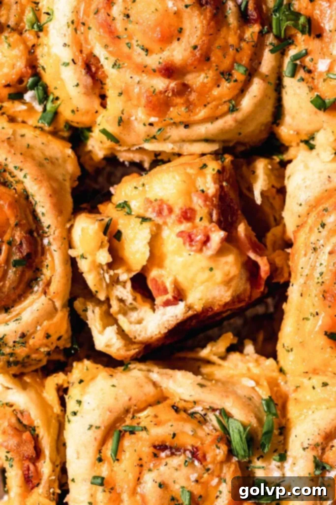torn apart roll with gooey cheese filling and bacon pieces