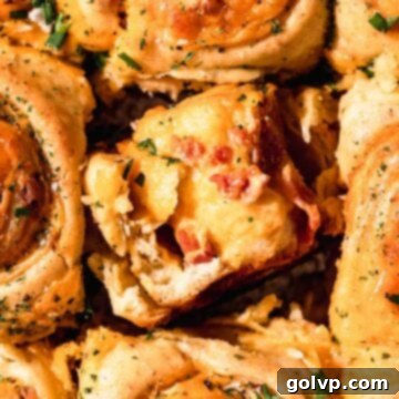 torn apart roll with gooey cheese filling and bacon pieces
