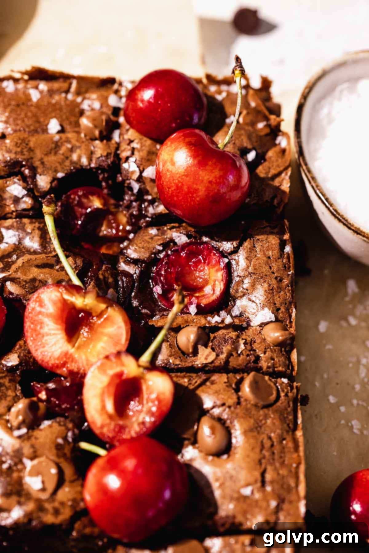 Decadent Cherry Brownies 3 Close up of a pan of fresh baked fudge brownies with cherries on top and showing the fudgy texture.