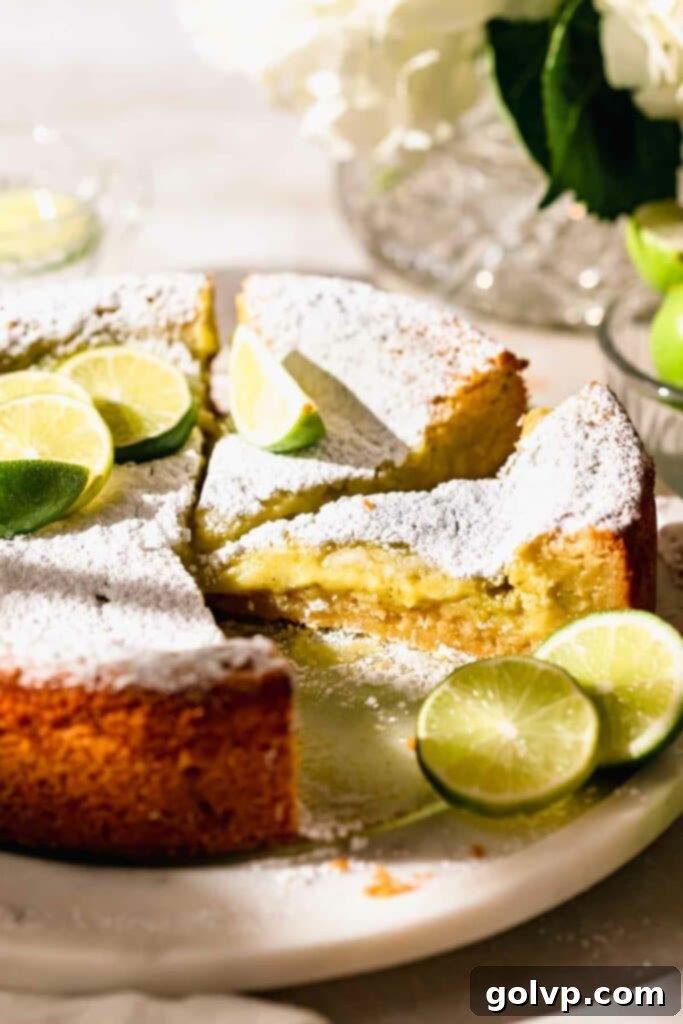 Lime cake with a generously gooey filling and a dusting of powdered sugar on top.
