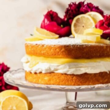 Zesty Lemon Victoria Sponge 13 Victoria sponge topped with powdered sugar, lemon slices, and peonies