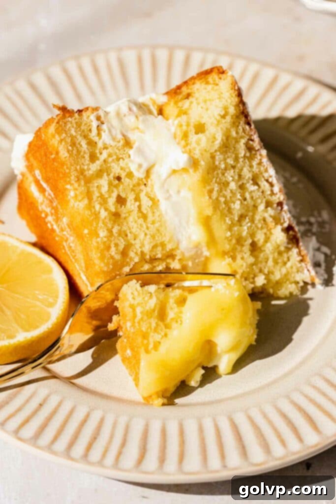 Zesty Lemon Victoria Sponge 4 Slice of victoria sponge and lemon on a plate