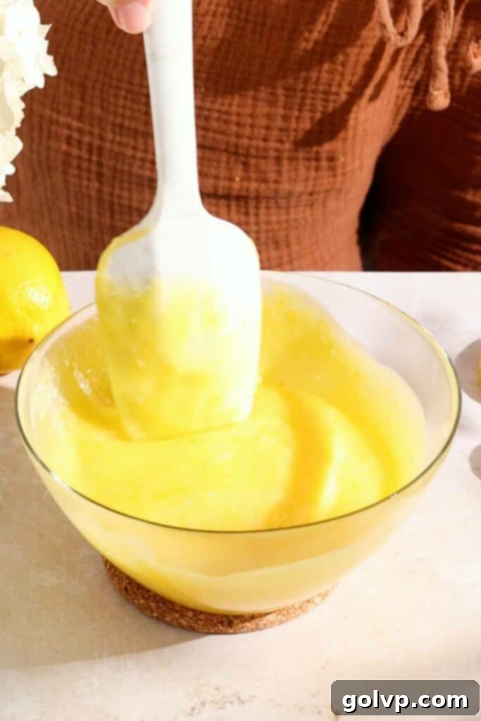 Zesty Lemon Victoria Sponge 7 mixing cooked curd and butter until smooth