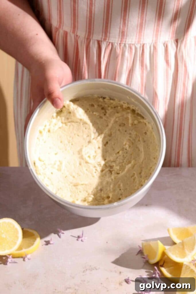 Three round cake layers in pans, ready to bake, showing even distribution of batter