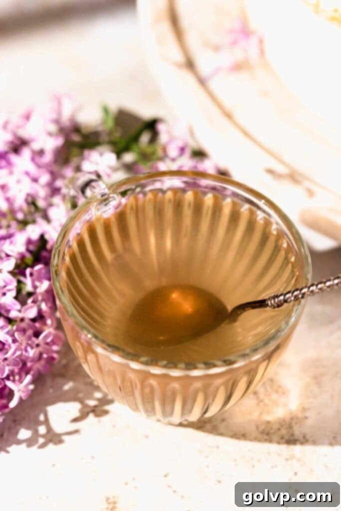 Beautiful slice of lilac lemon cake on a fluted plate with a fork, showcasing the texture