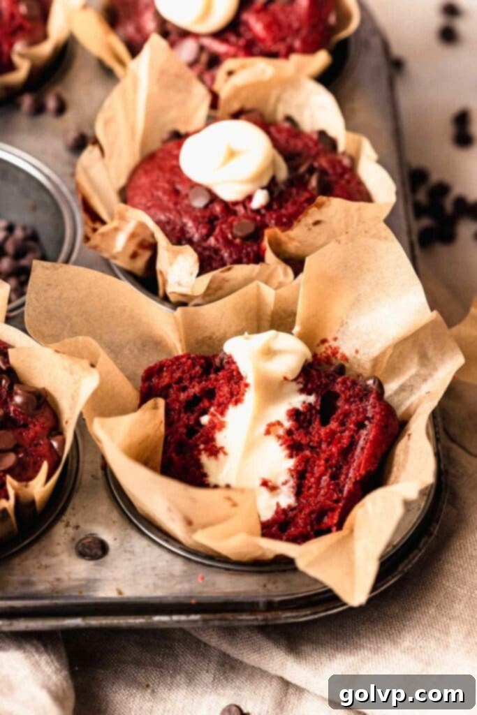 cut red velvet muffin with cream cheese filling visible