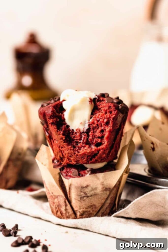 Stack of red velvet muffins filled with cream cheese