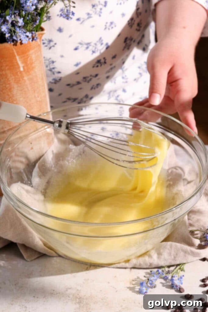 whisking eggs and sugar until thick for red velvet muffin batter