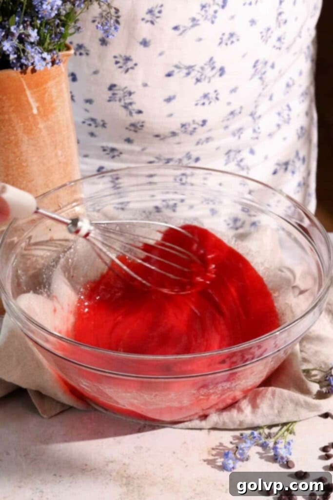 adding red food colouring to muffin batter