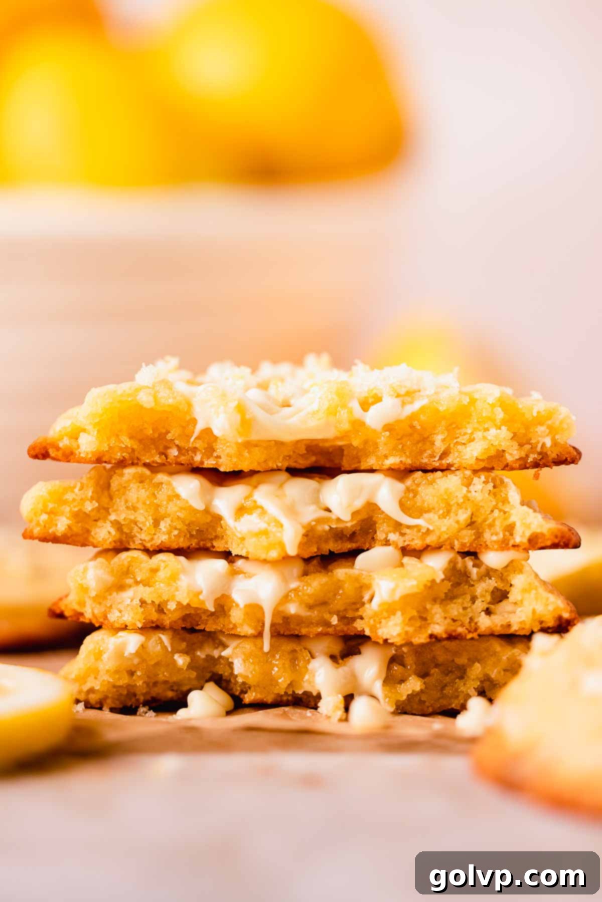 A stack of perfectly baked lemon white chocolate chip cookies, showing their soft centers and slightly crisp edges.