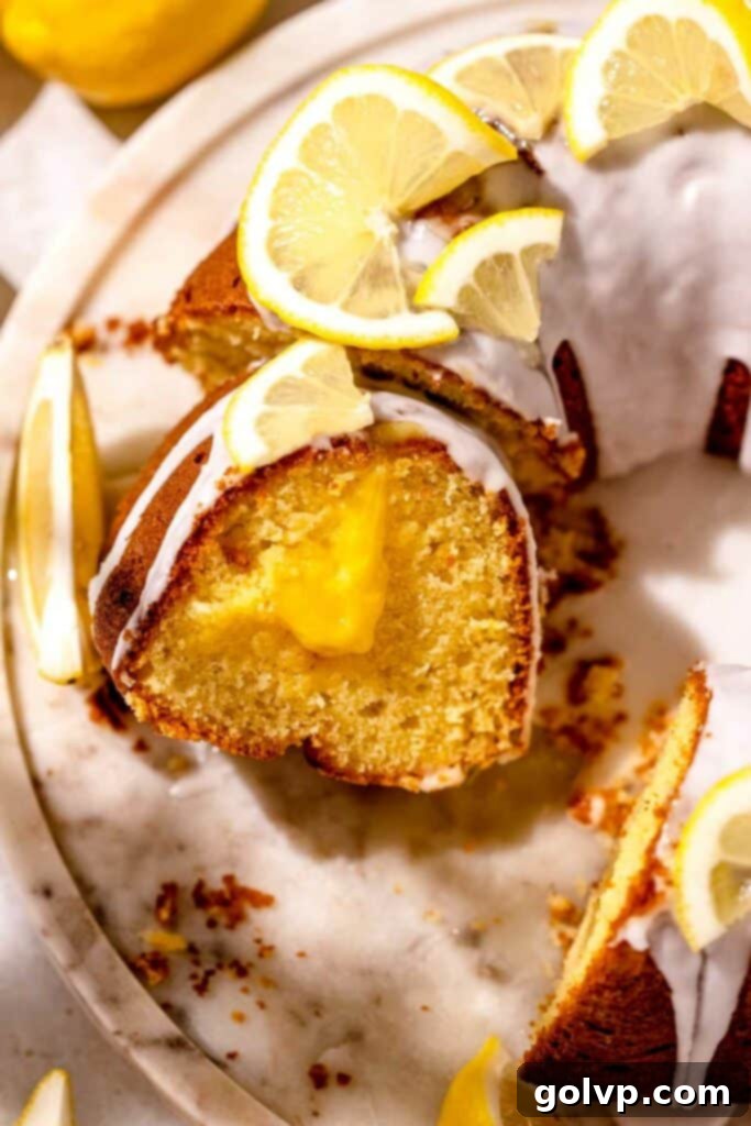 Sunshine Lemon Bundt 2 Sliced lemon bundt cake with a visible gooey lemon curd filling and a tangy glaze