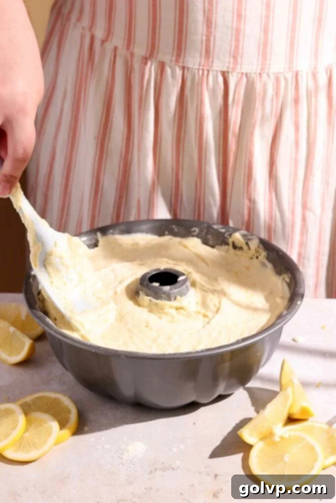 Sunshine Lemon Bundt 7 Adding thick batter into the bundt pan